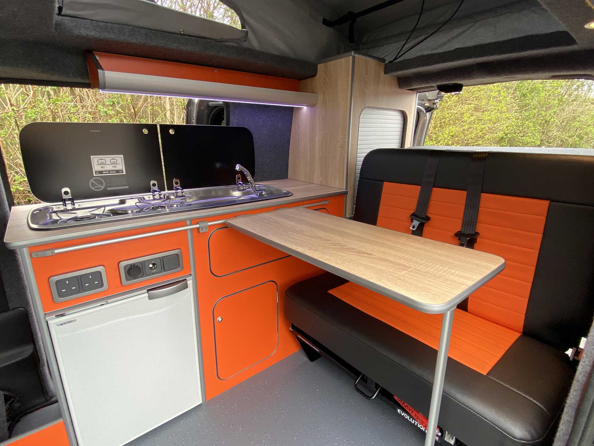 bright orange and black camper van conversion interior