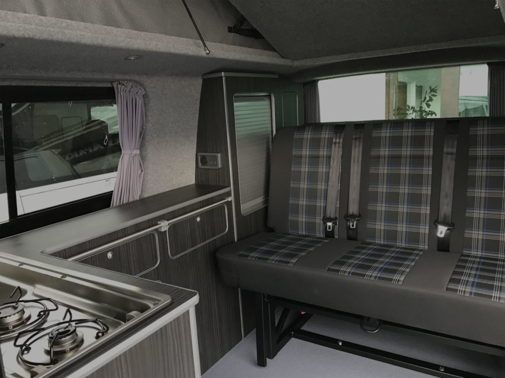 hudson campervan interior design with black ash style wood effect finish and tartan seat upholstery