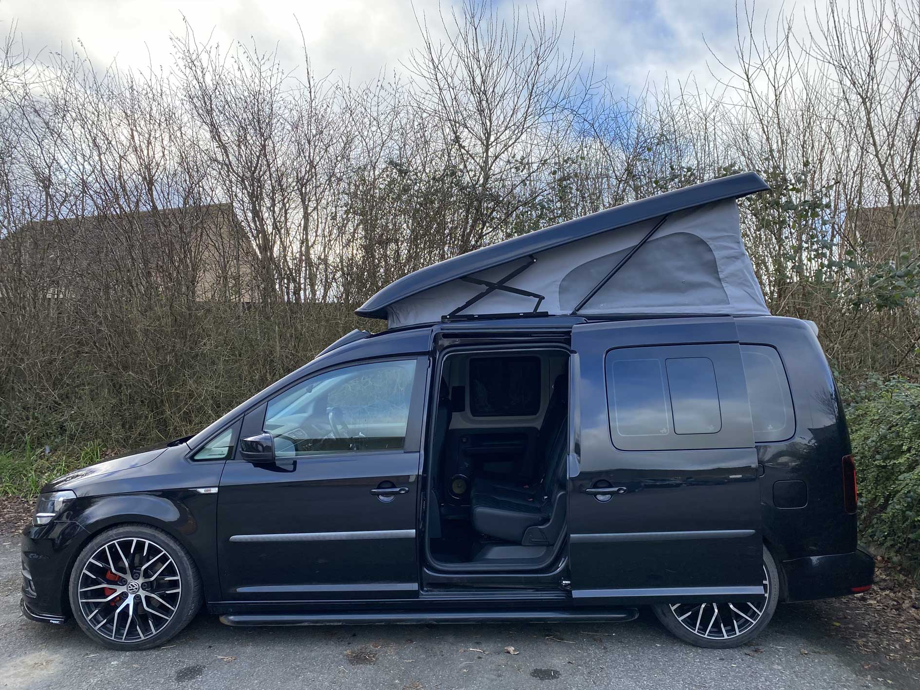 small black van with small elevating pop-up roof