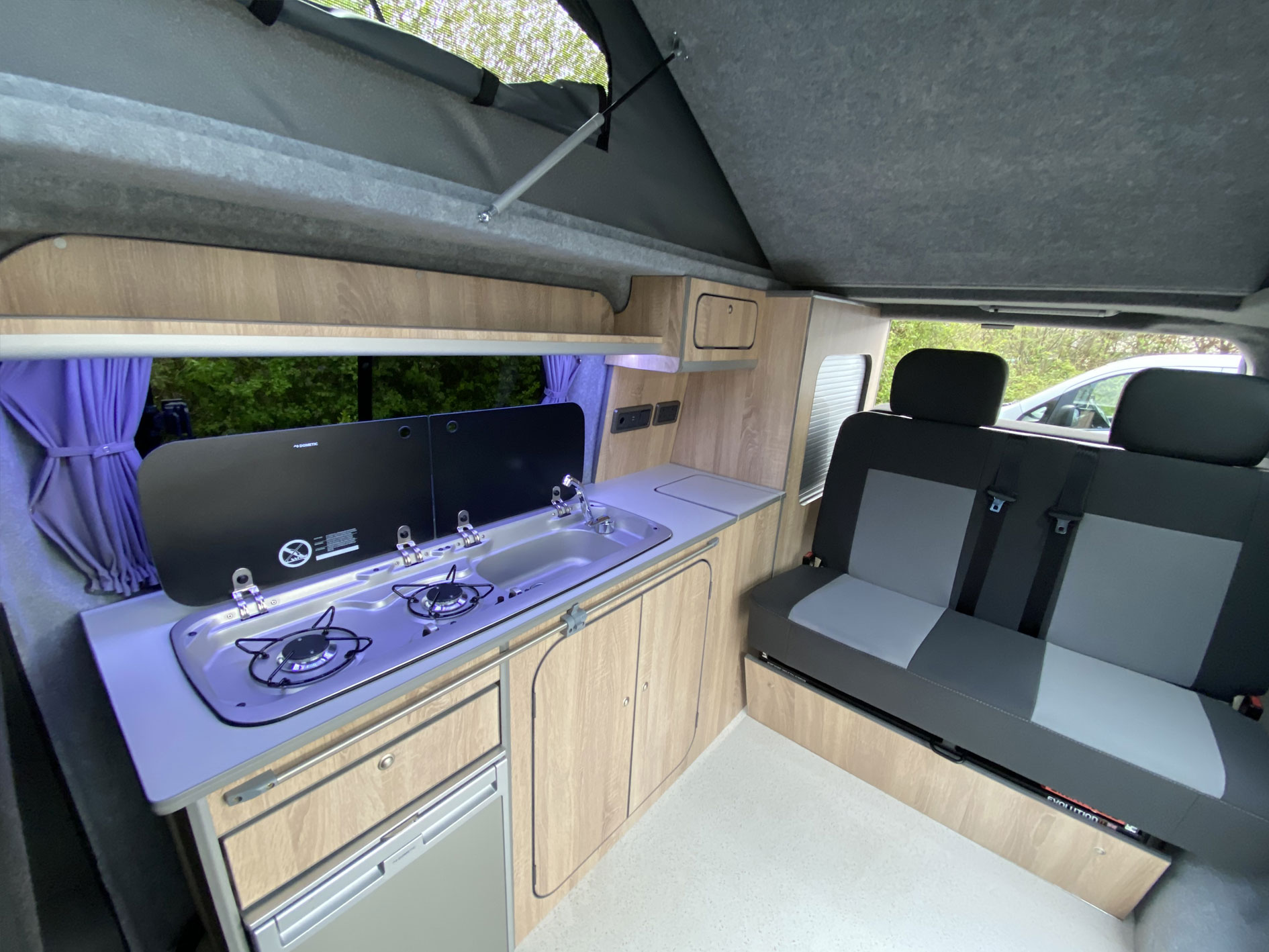 hudson camper van conversion with light wood effect and grey upholstery