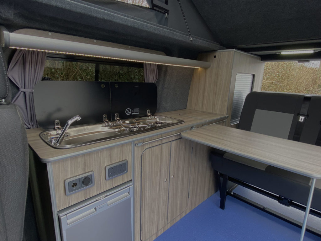 hudson campervan interior design with wood effect finish and plain charcoal and grey seat upholstery